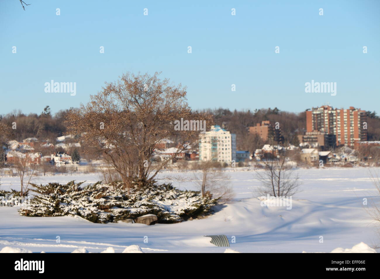 Barrie,Ontario , Canada , a city shot from across the lake,city skyline, winter day, frozen lake, blue sky Stock Photo