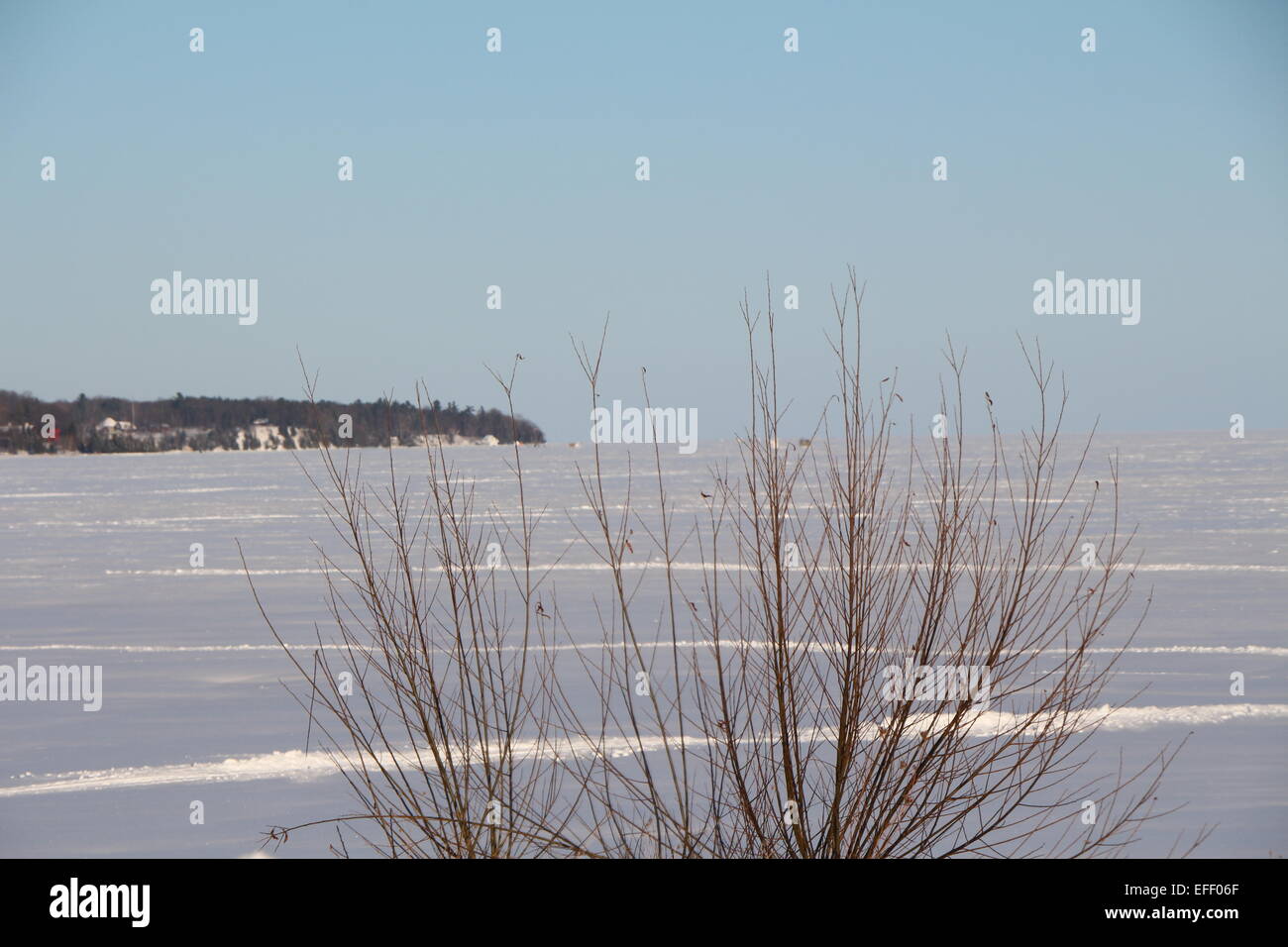 Barrie , Ontario , Canada , lake Simcoe frozen over, snow covered lake with a blue sky Stock Photo