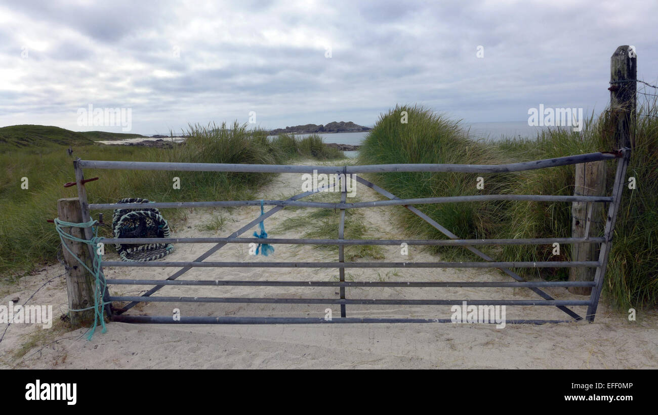 A gate across the path leading to Traigh an t-Suidhe ( Beach of the Seat) on the island of Iona Scotland Stock Photo
