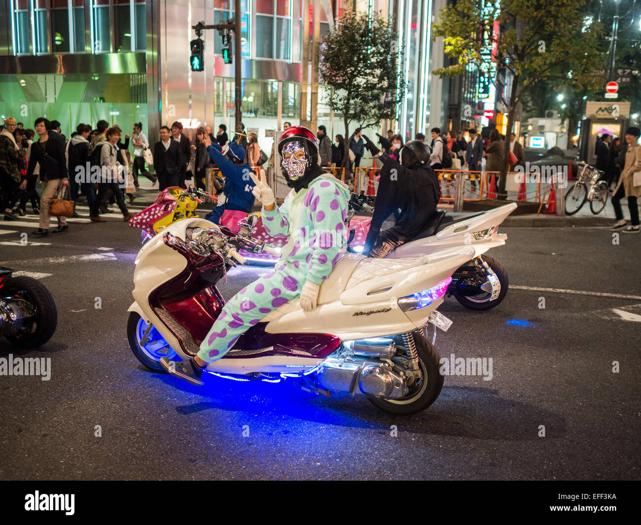 People dressed for Halloween driving futuristic motorcycles in Shinjuku Stock Photo