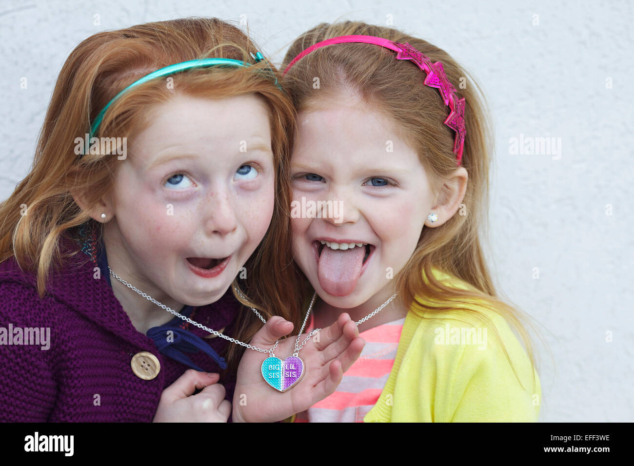Two sisters with red hair acting silly together. Stock Photo