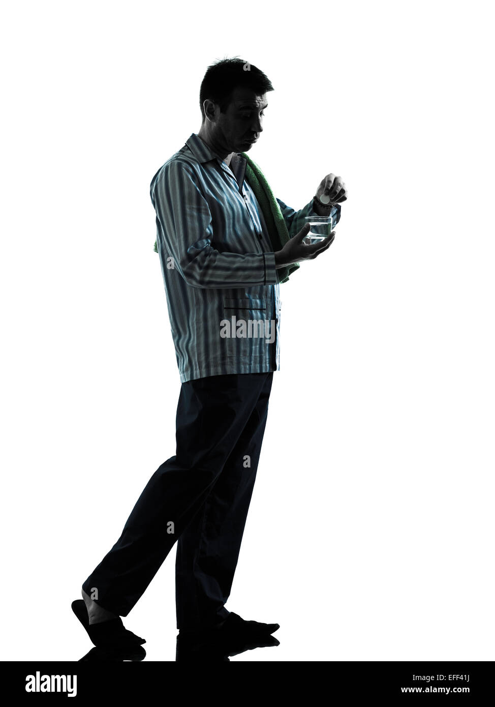 one man man pajamas taking medicine effervescent stomach ache pain in pajamas silhouettes on white background Stock Photo