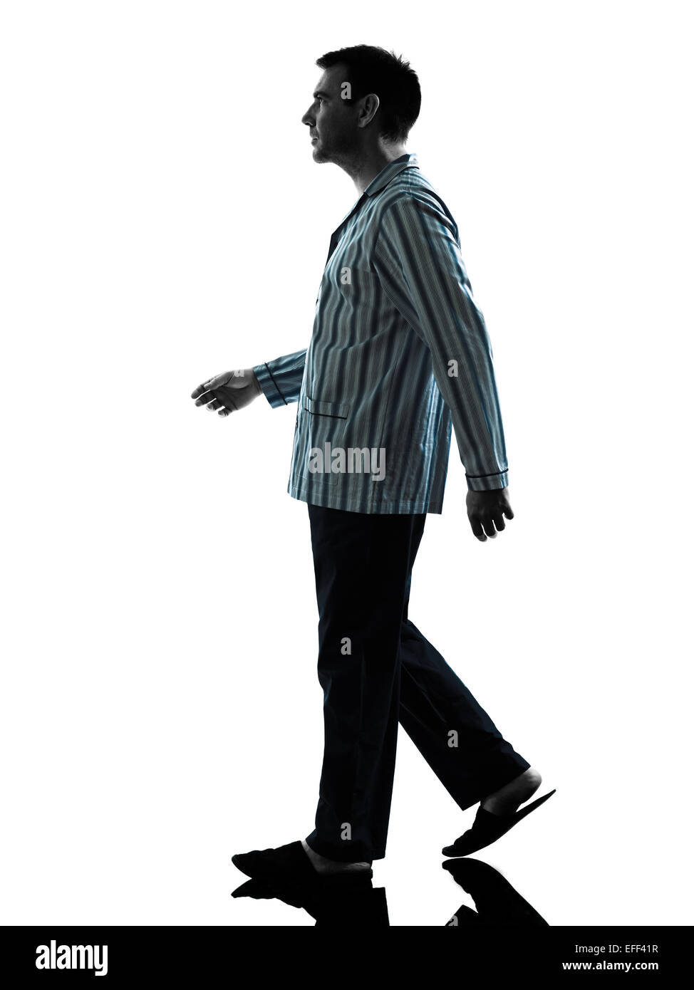 one man in pajamas walking silhouettes on white background Stock Photo