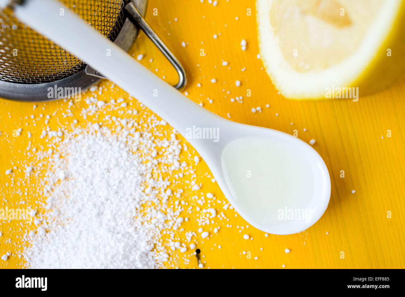 Lemon juice in the spoon near squeezed lemon and citric acid Stock