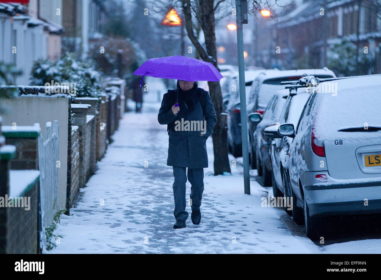 South London, UK. 03rd Feb, 2015. Picture shows a early morning commuter making his way along a snow laden street in Wimbledon, South Wimbledon, where there has been snow showers across parts of London. Credit:  Jeff Gilbert/Alamy Live News Stock Photo