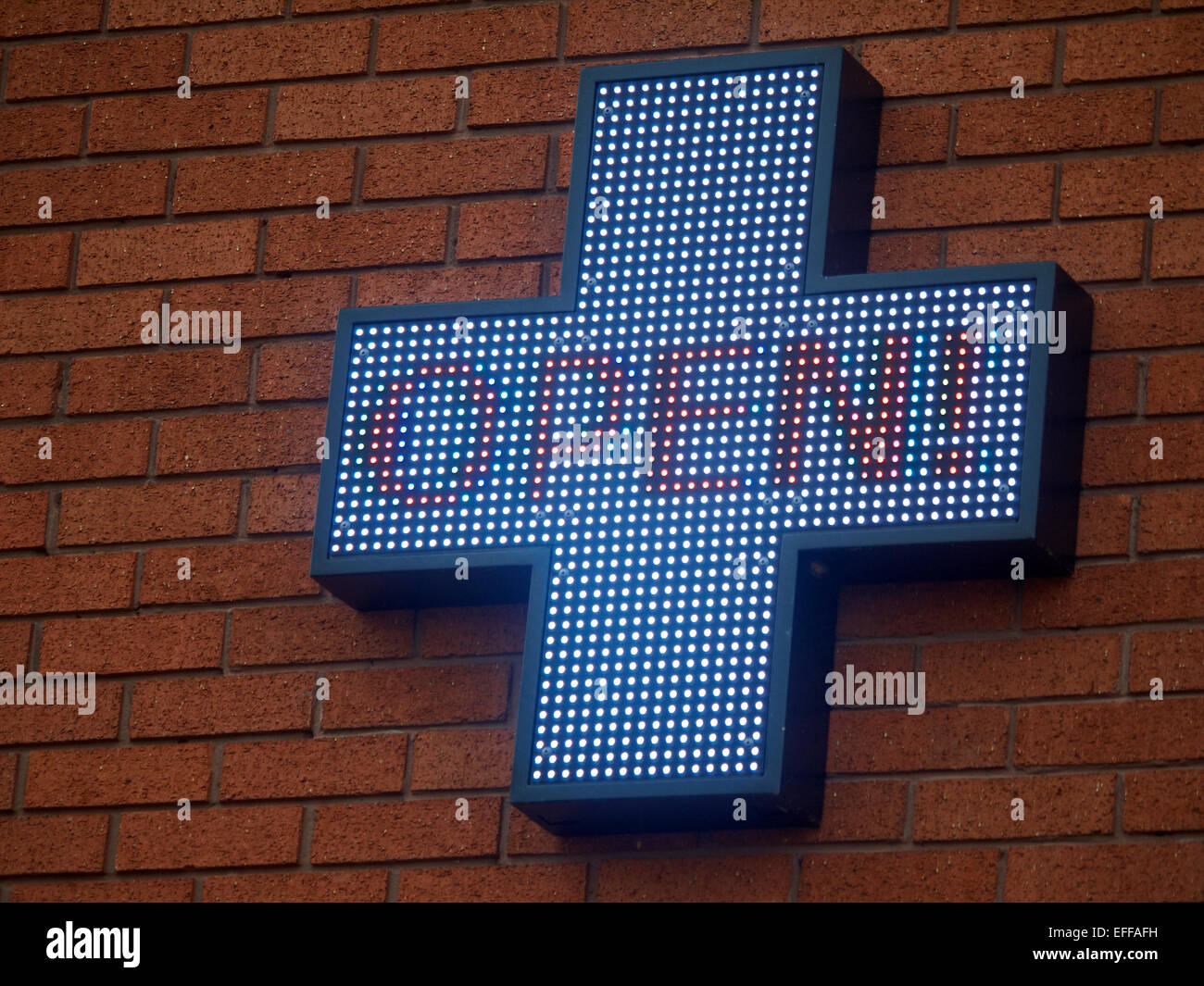 Pharmaceutical cross on outside wall UK Stock Photo