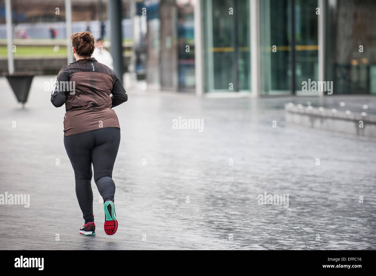 A jogger on the South Bank in London. Stock Photo