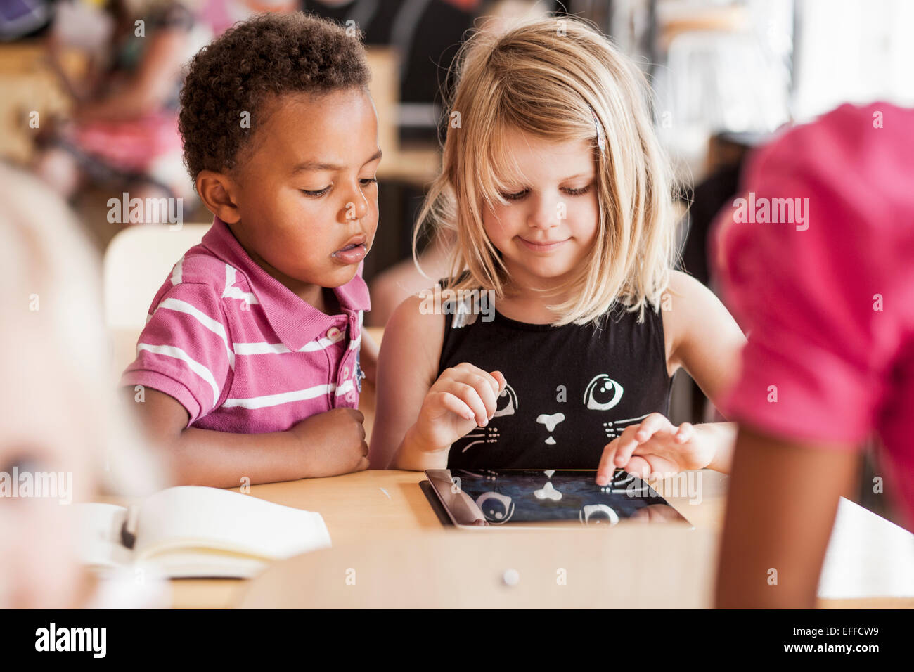 Children using digital tablet in classroom Stock Photo Alamy