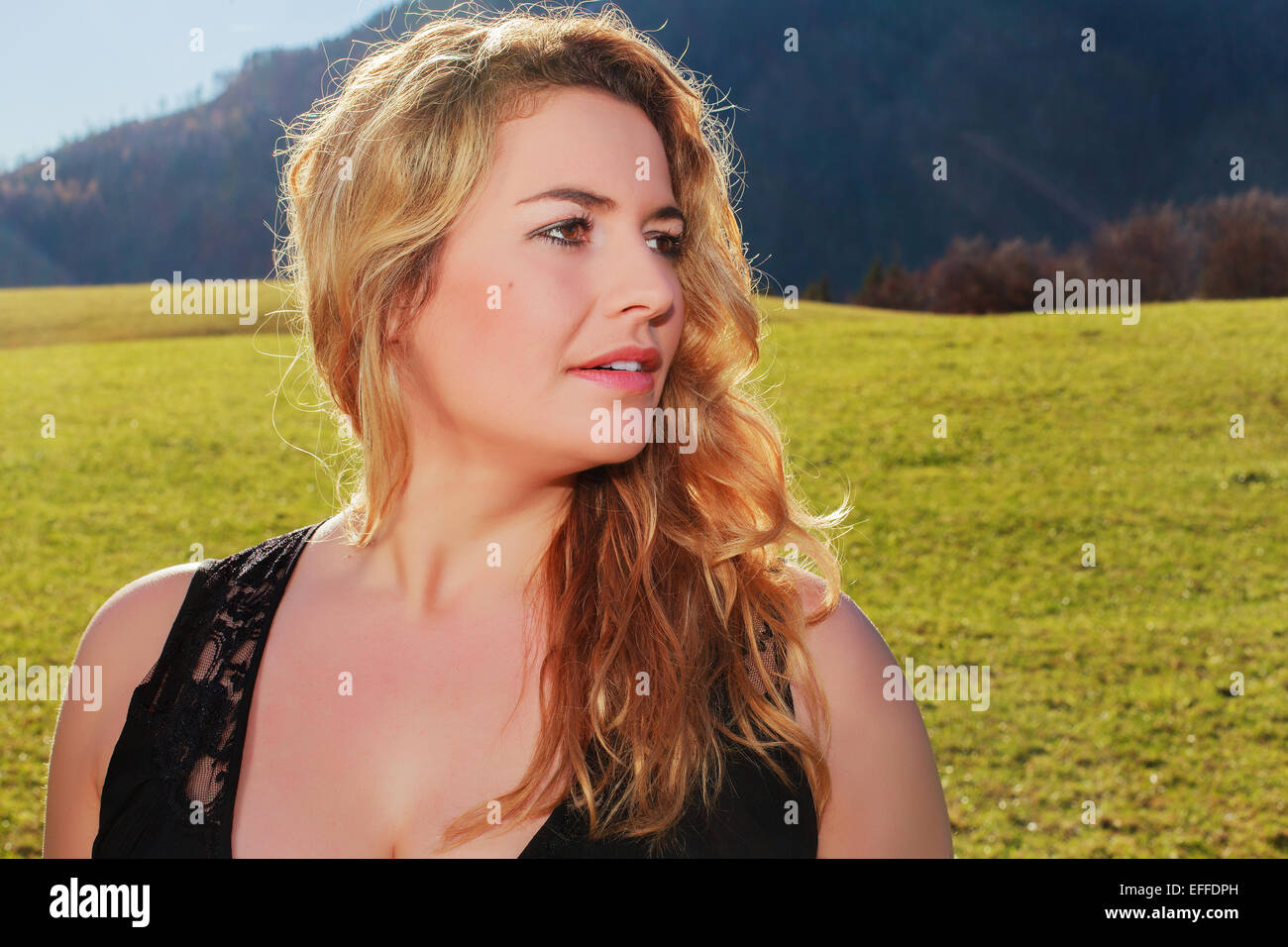 Portrait of a woman with long blond hair and oversize Stock Photo