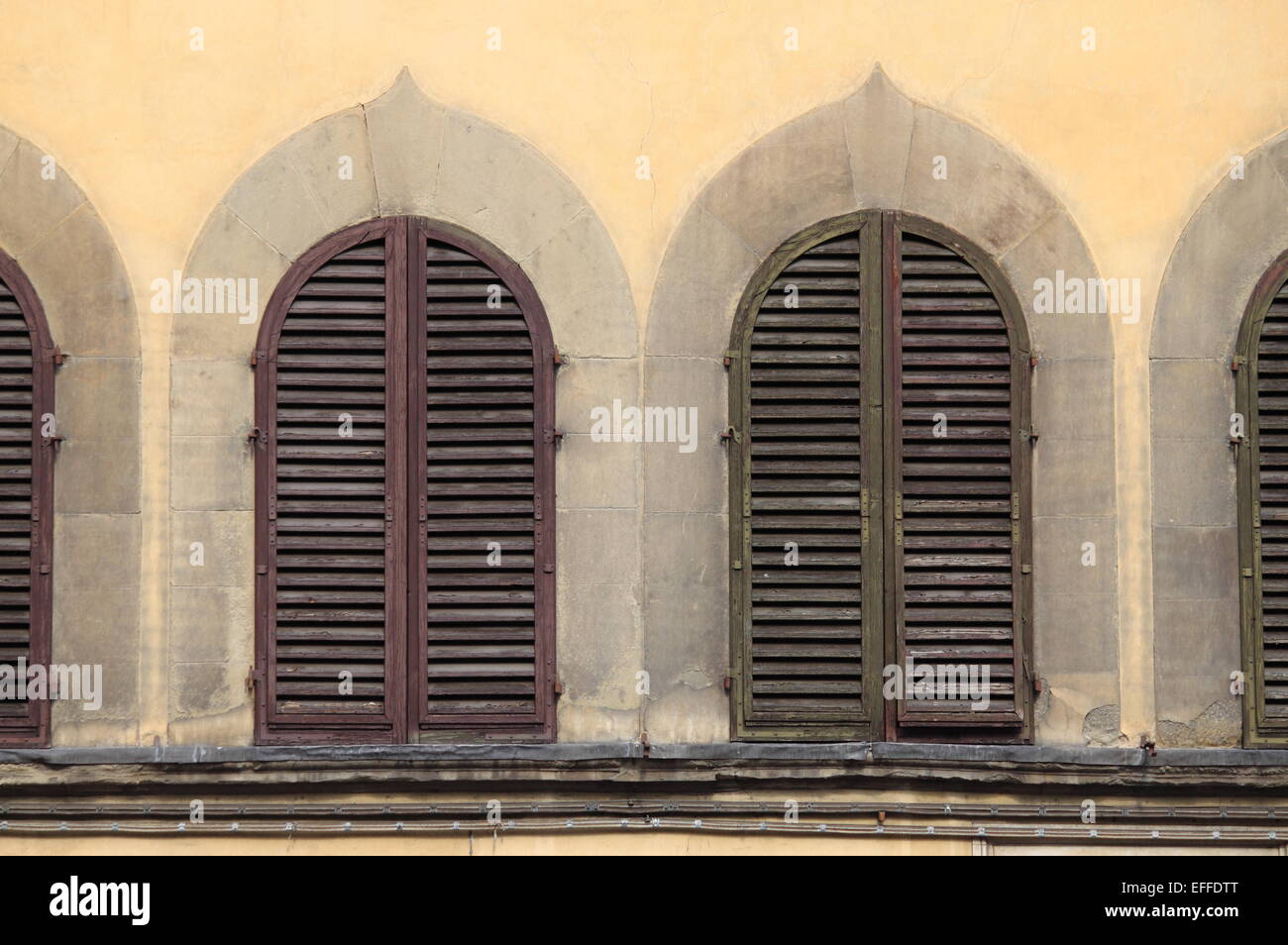 Arched windows with closed shutters Stock Photo