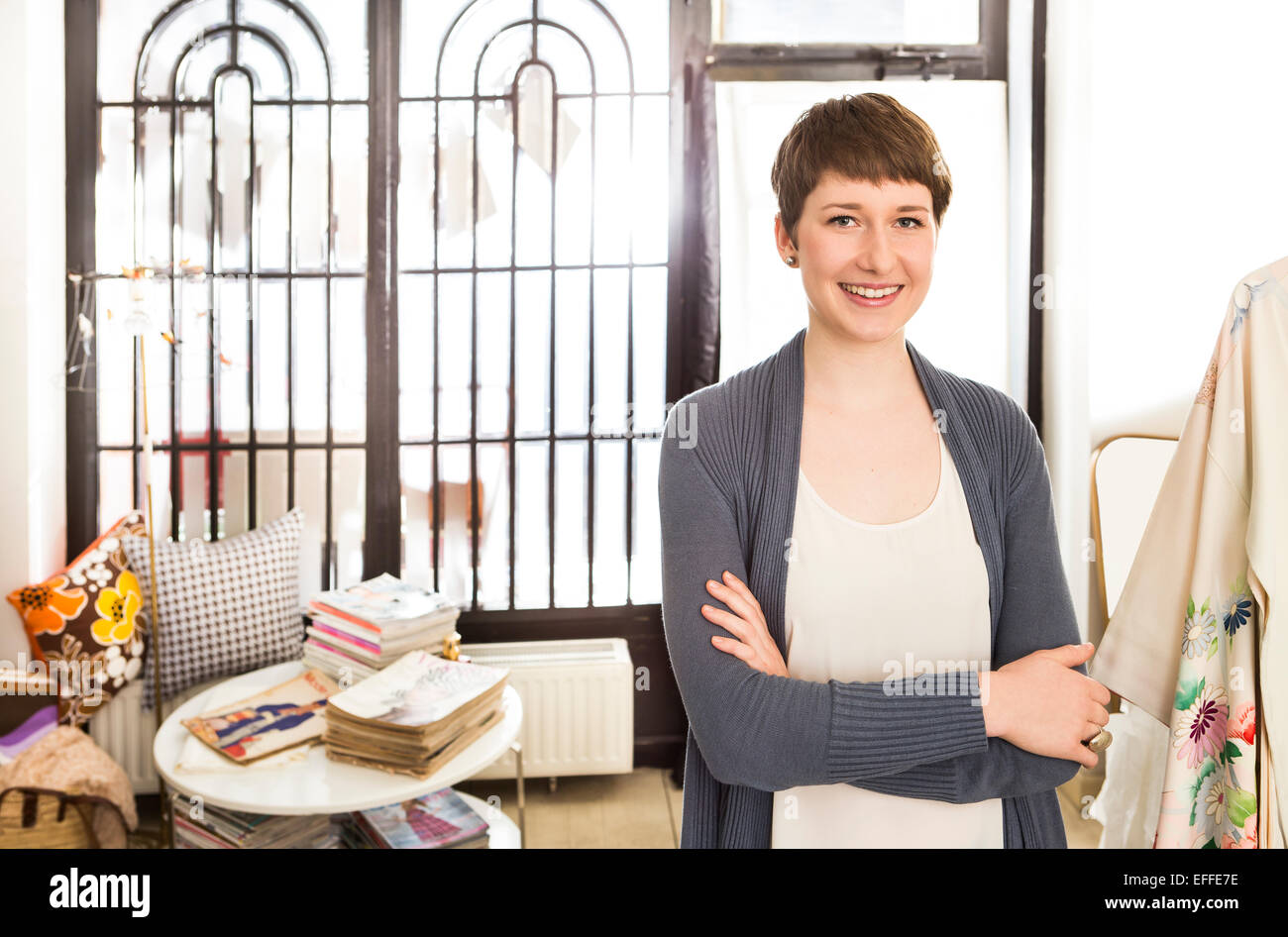 Portrait of smiling female fashion designer at her studio Stock Photo ...