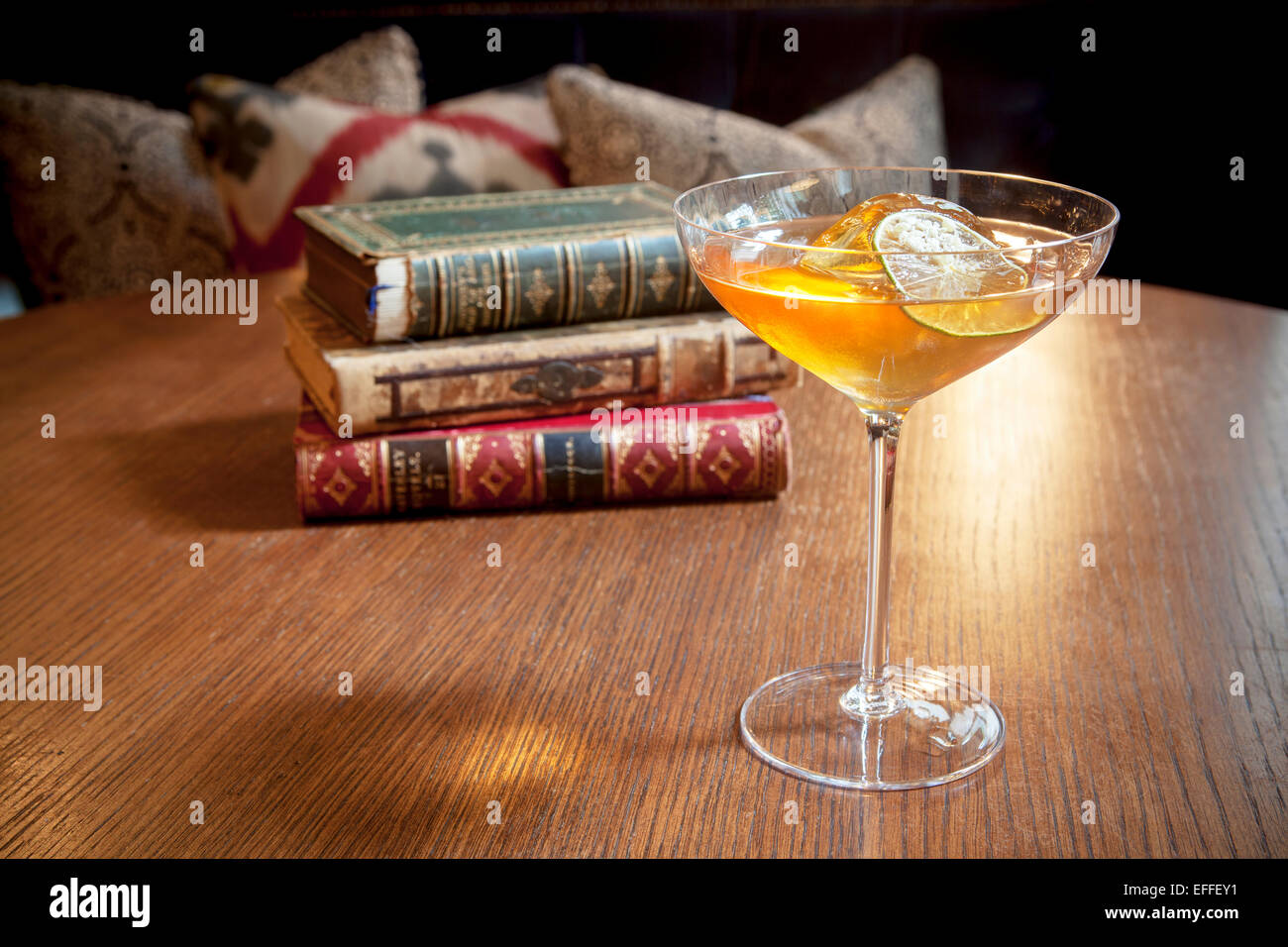 Cocktail on Table with Old Books at Rosewood Hotel in London Stock Photo