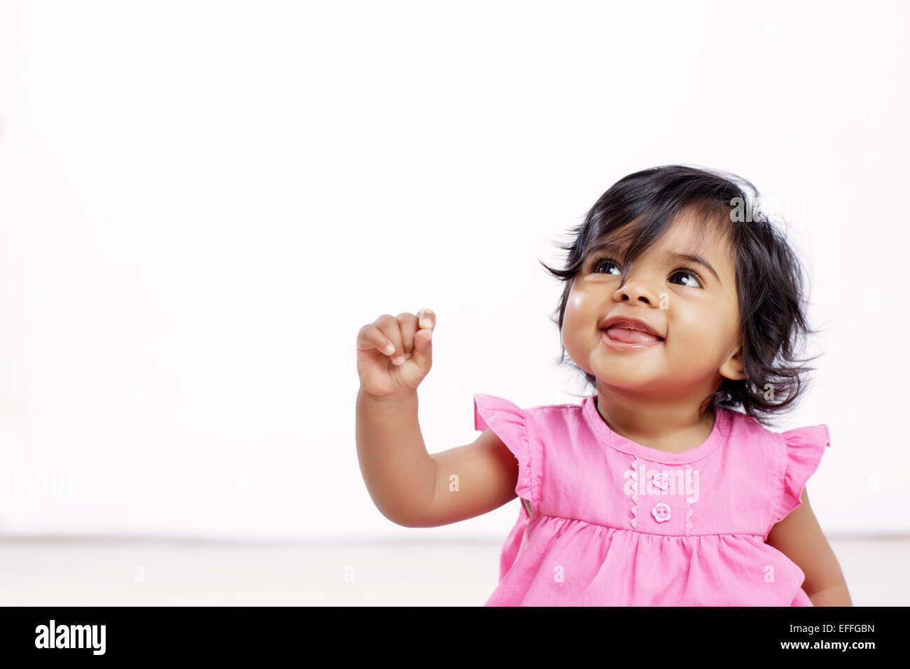 Portrait of baby girl looking up Stock Photo - Alamy