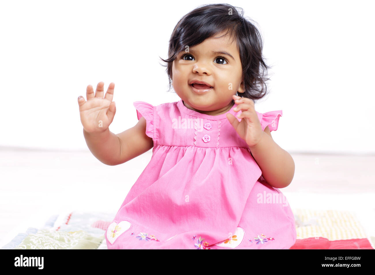 Portrait of smiling baby girl wearing pink dress Stock Photo - Alamy