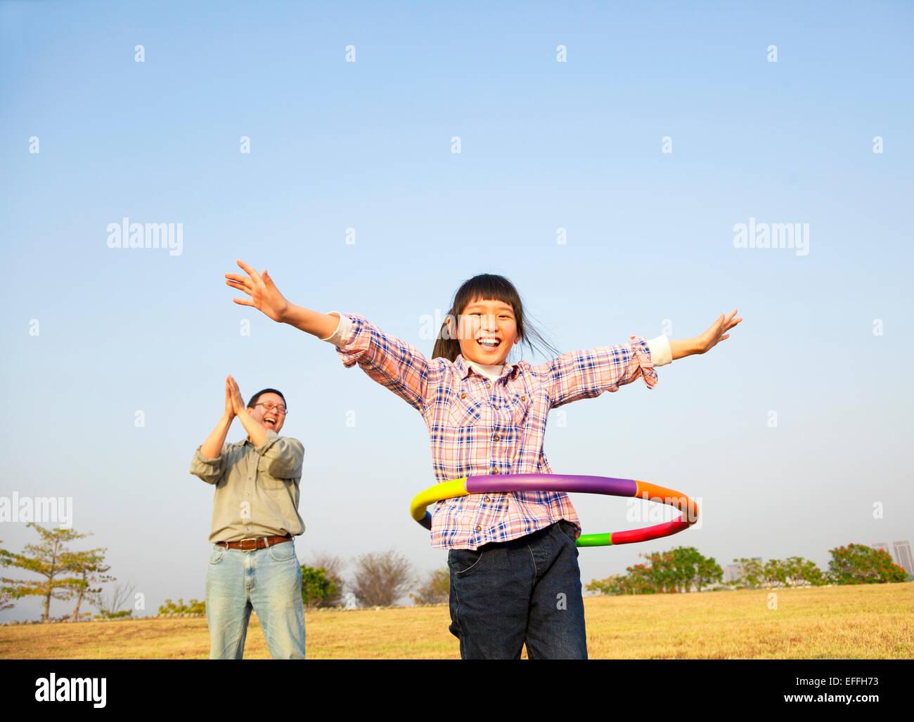 happy kid playing  hula hoops outdoors Stock Photo