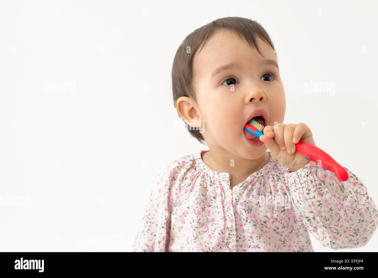 little girl brushing her teeth Stock Photo