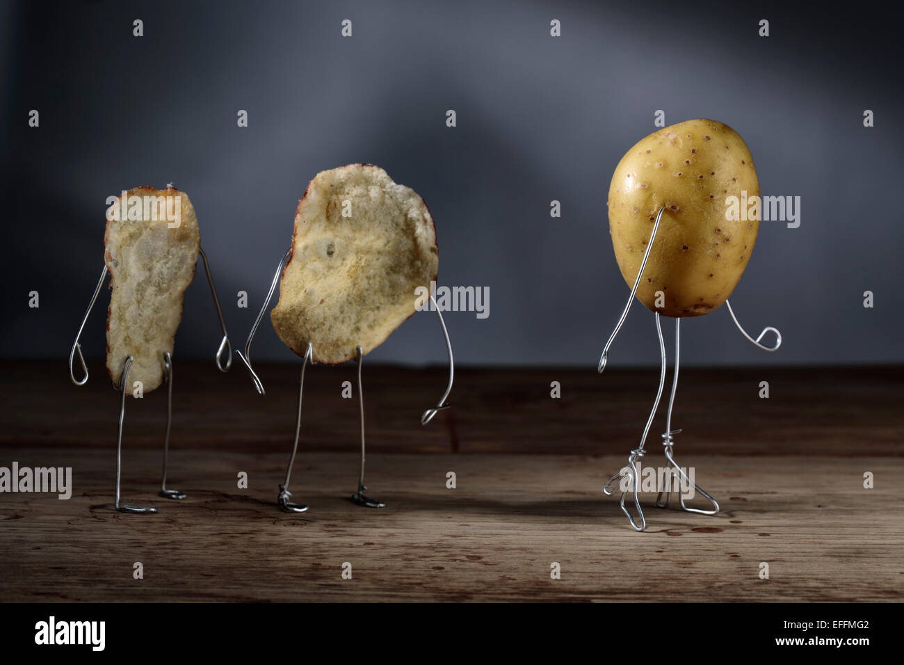 Potato chip manikins watching potato girl Stock Photo Alamy