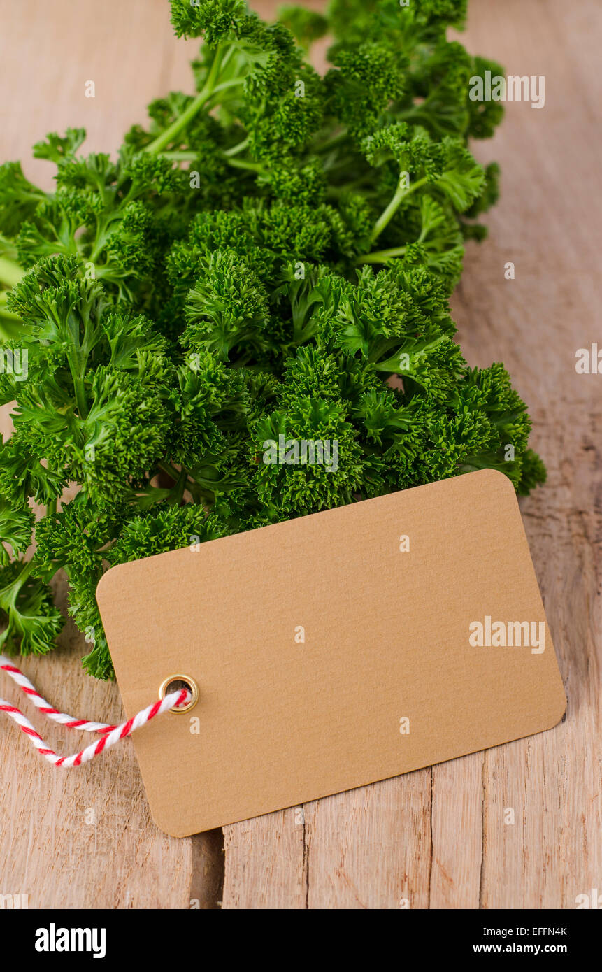 Frizzy parsley and blank label on wood Stock Photo