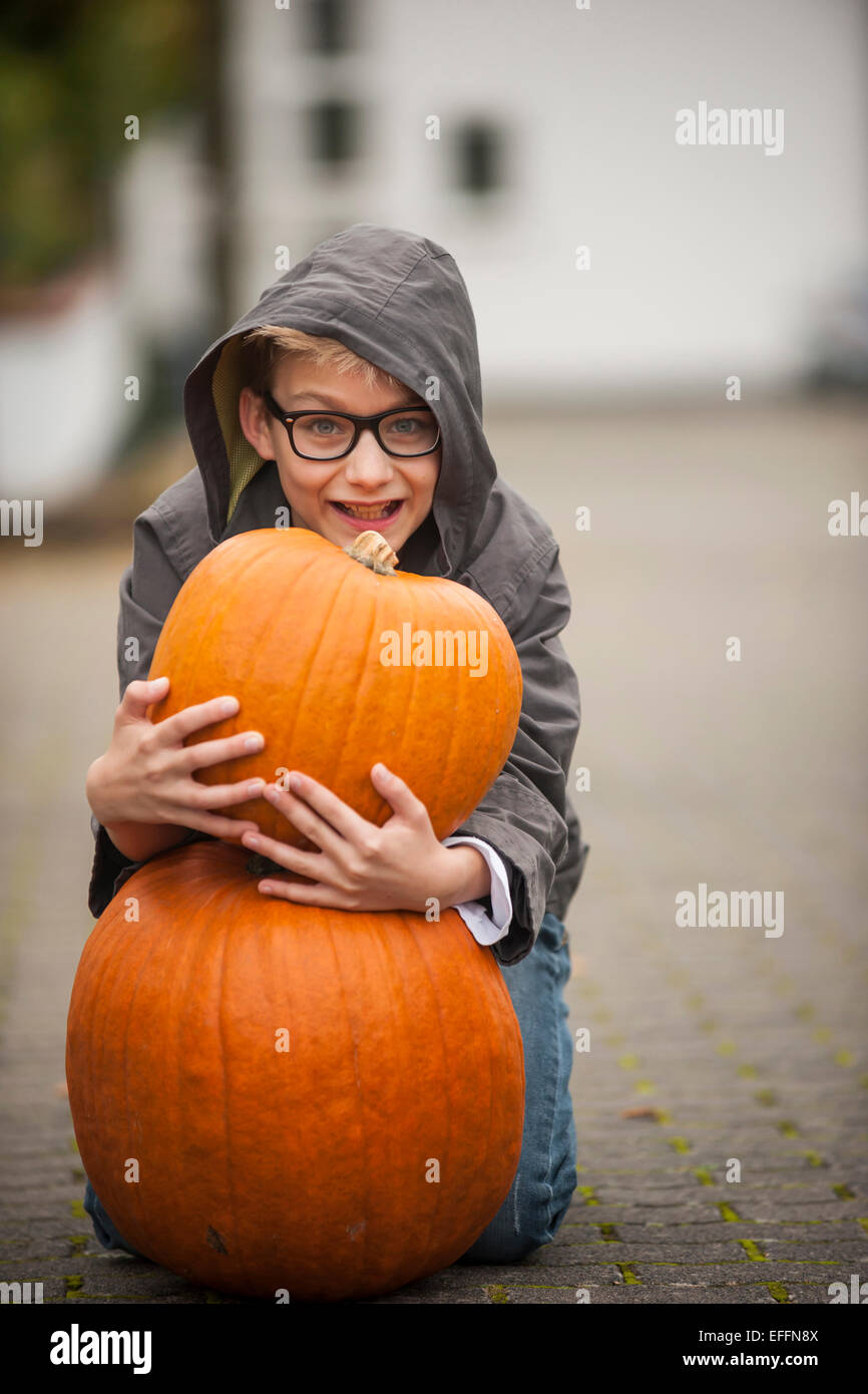 Smiling boy with two big pumpkins Stock Photo