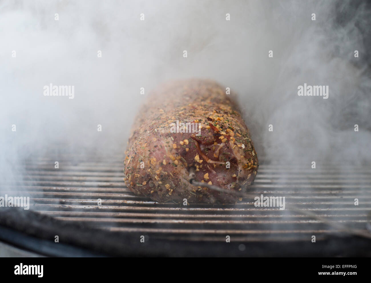 Bacon wrapped pork fillet on grill Stock Photo Alamy