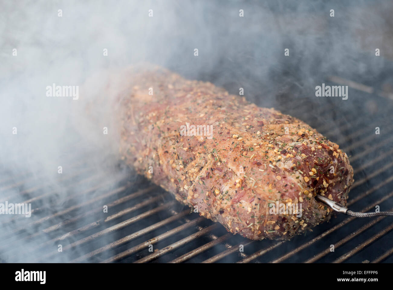 Pork fillet wrapped in bacon on grill Stock Photo Alamy