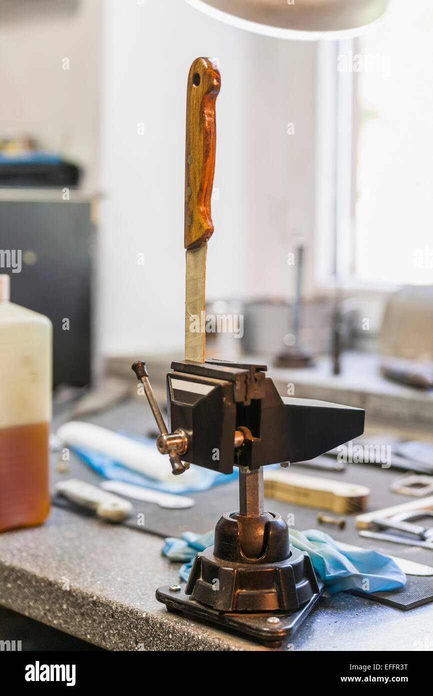 Knife in bench vice in a of a knife maker Stock Photo Alamy