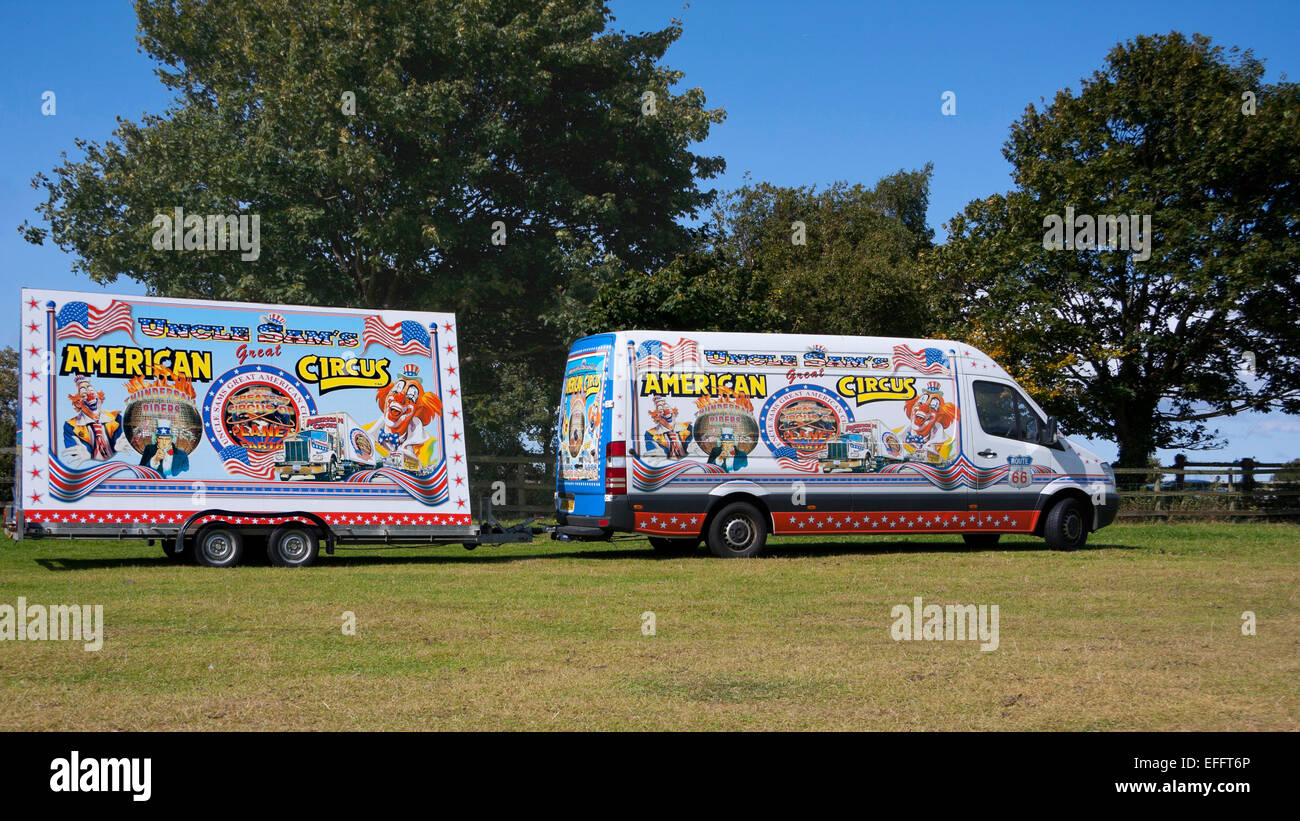 Truck and trailer from Uncle Sam's Great American Circus in a green field with a blue sky. Stock Photo