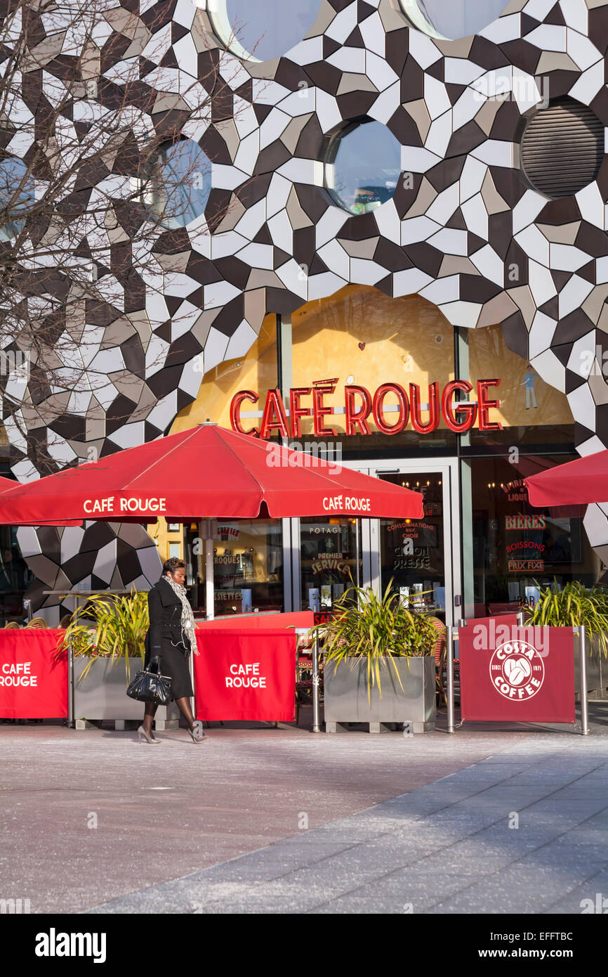 Café Rouge nestles under the striking modern architecture of Ravensbourne College at Greenwich Peninsula Square, London UK in February Stock Photo