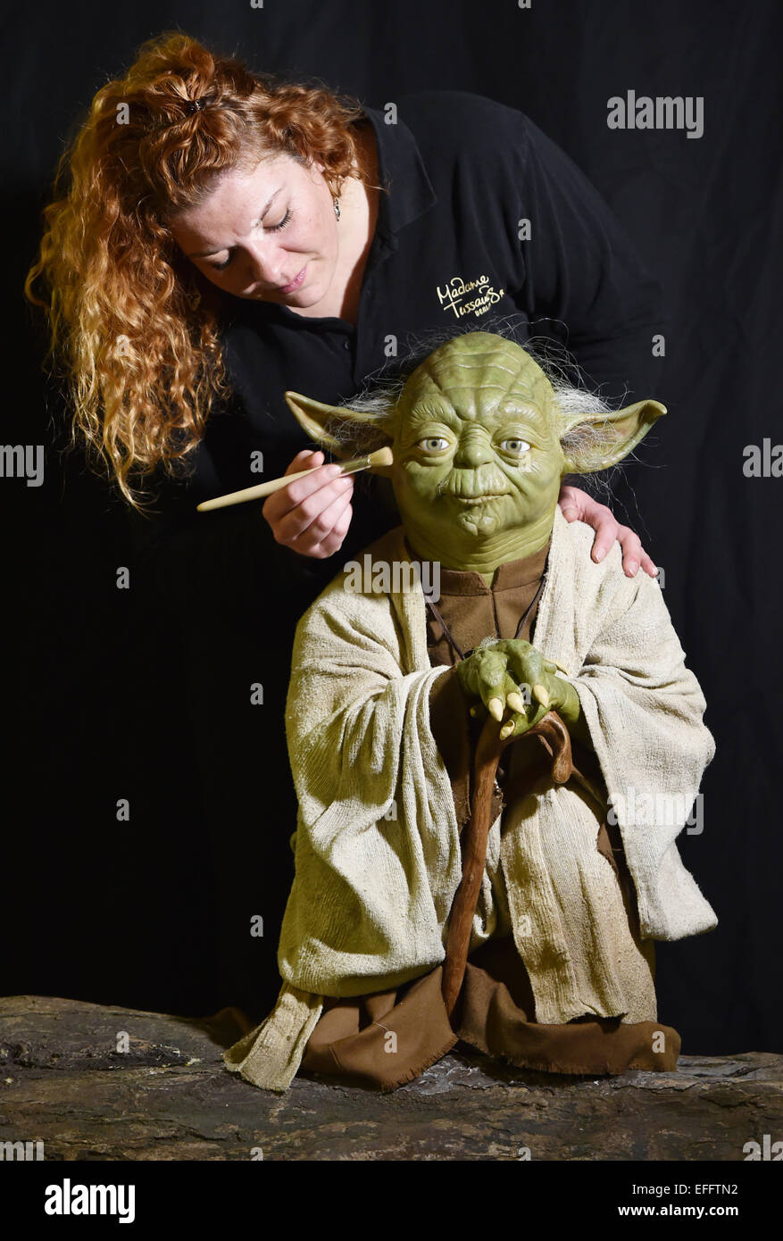 Berlin, Germany. 02nd Feb, 2015. The wax figure of Star Wars hero Yoda for the London Madame Tussauds is inspected by press speaker Nina-Kristin Zerbe in the wax museum in Berlin, Germany, 02 February 2015. Starting in May 2015 key scenes from the Star Wars films will be shown on authentic and accessible sets at the Berlin and London Madame Tussauds museums. Photo: JENS KALAENE/dpa/Alamy Live News Stock Photo