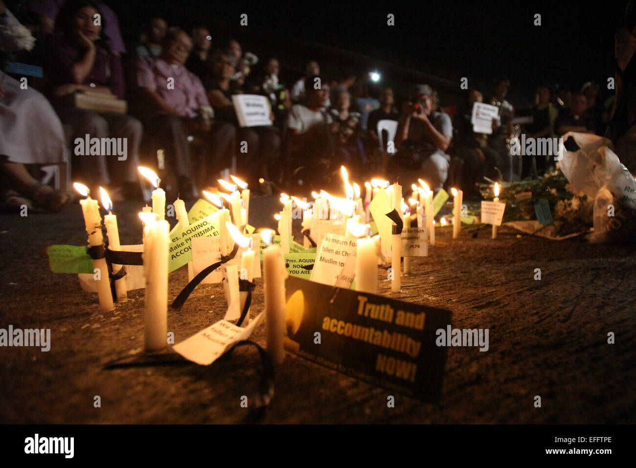 (150203) -- QUEZON CITY, Feb. 3, 2015 (Xinhua) -- People light candles and offer flowers and prayers for the slain 49 members of the Philippine National Police Special Action Force(PNP-SAF) at the gate of the PNP Headquarters in Quezon City, the Philippines, Feb. 3, 2015. There was lack of coordination and planning between the military forces and the leadership of the PNP-SAF during the violent clash in Mamasapano, Maguindanao on Jan. 25, chief of the Armed Forces of the Philippines said on Tuesday. (Xinhua/Rouelle Umali) (lmz) Stock Photo