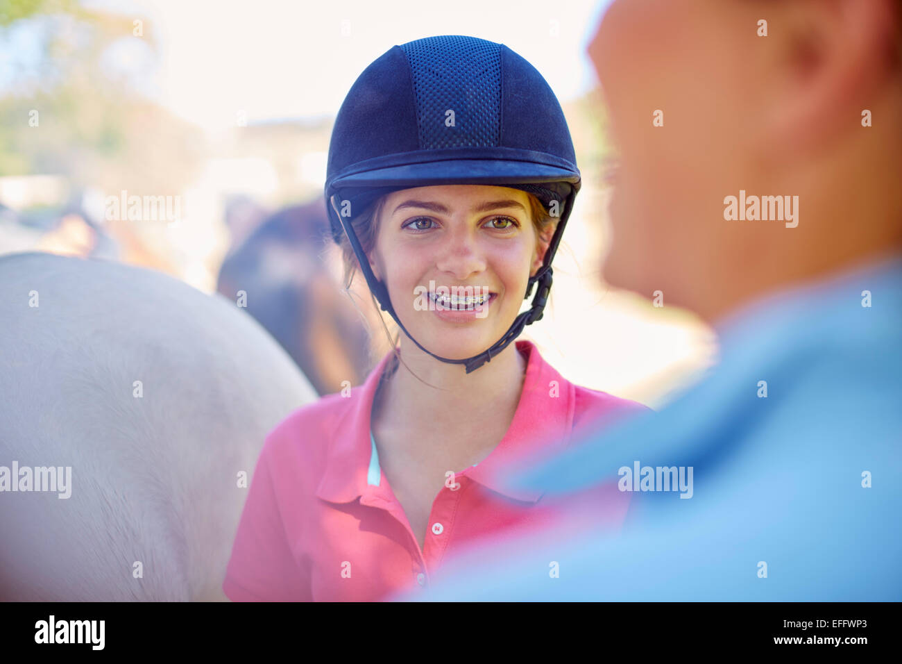 Smiling girl with braces wearing riding helmet Stock Photo Alamy