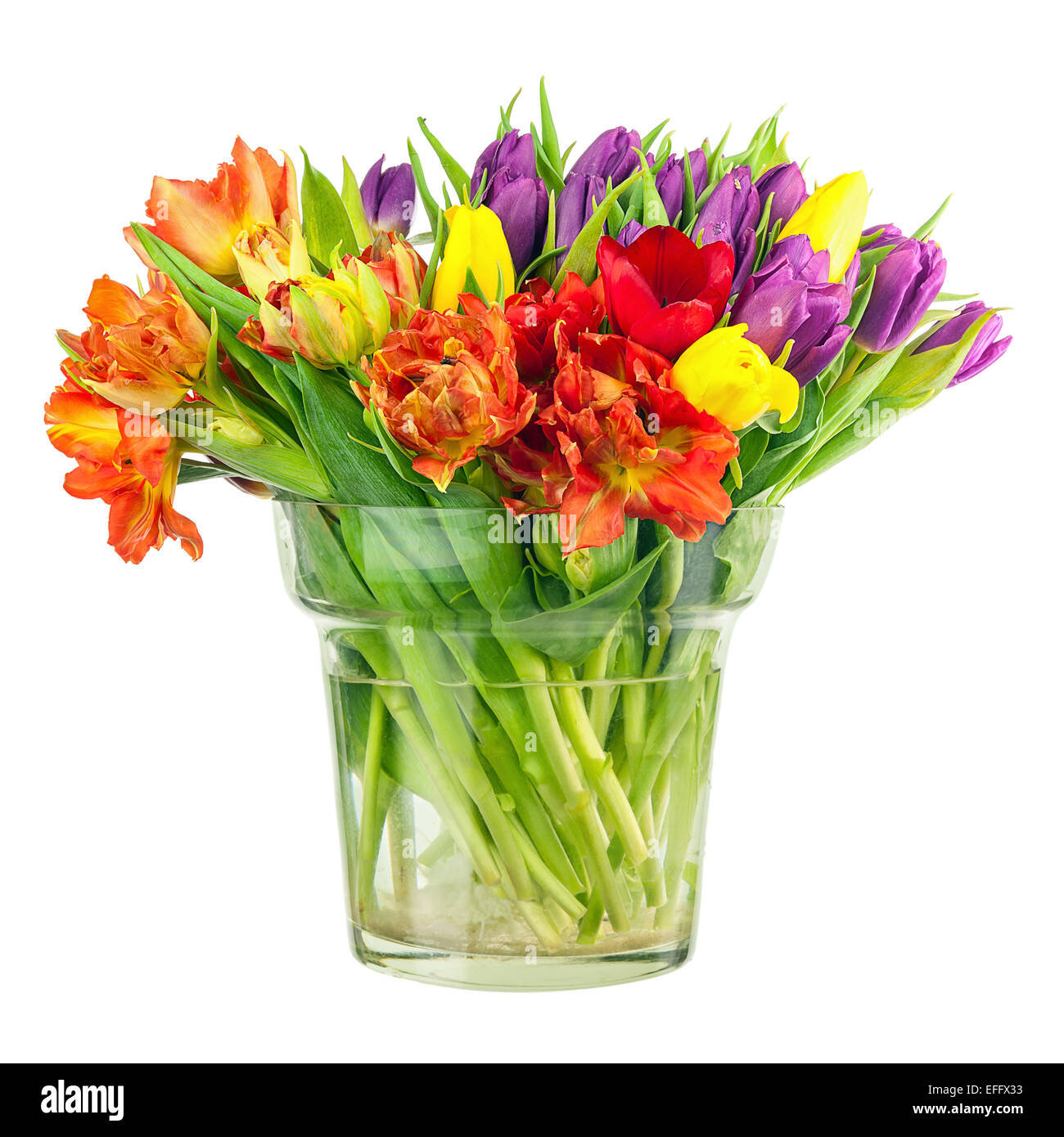 Flower bouquet from colorful tulips in glass vase isolated on white ...