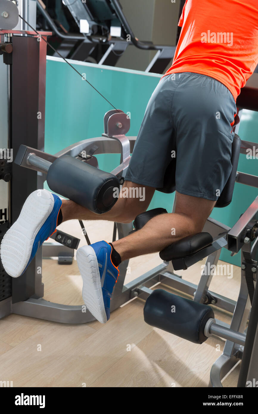 Kneeling leg femoral curl man exercise at gym rear view workout Stock Photo Alamy