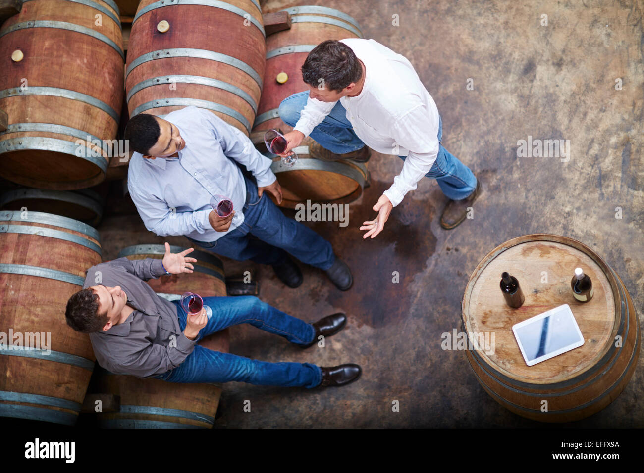 Wine makers tasting wine in wine cellar Stock Photo - Alamy
