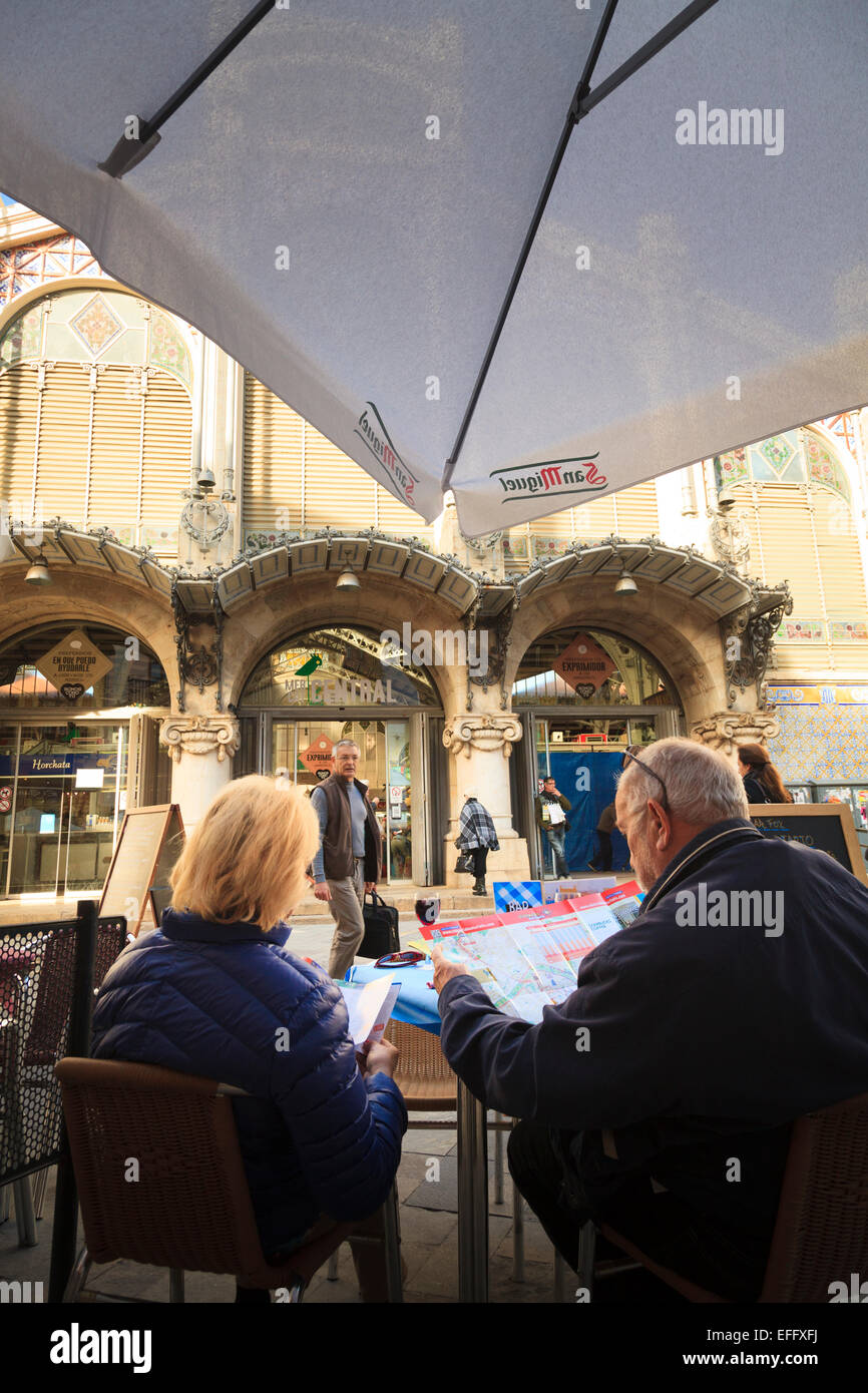 Two Tourists study a tourist map outside the central market in Valencia Stock Photo