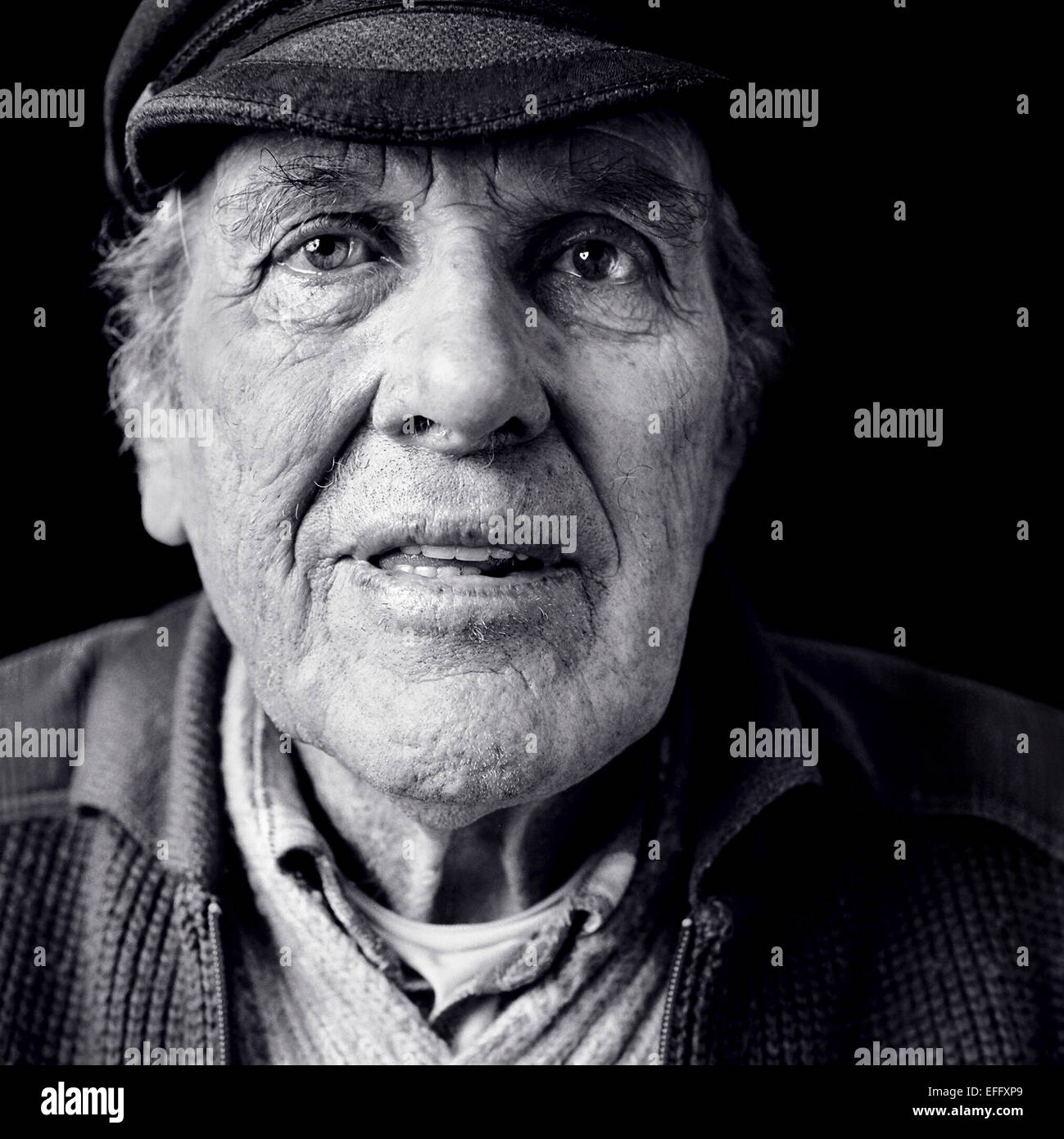 Close up portrait of ageing fisherman wearing cloth cap, black and white Stock Photo