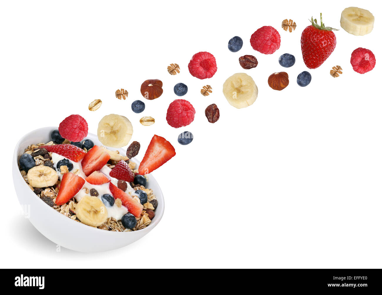Flying fruit muesli for breakfast with fruits like raspberry, blueberries, banana and strawberry Stock Photo