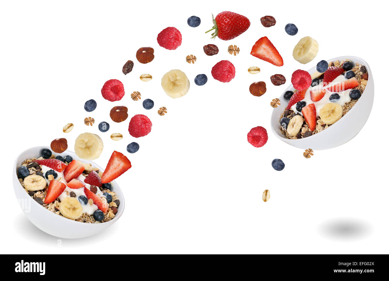 Flying fruits from fruit muesli for breakfast with raspberry, blueberries, banana and strawberry Stock Photo