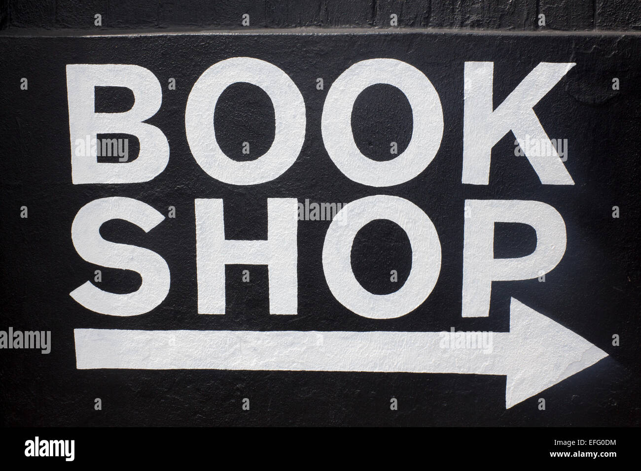 Book Shop sign white writing on black background with white arrow below pointing to right Newcastle NSW Australia Stock Photo