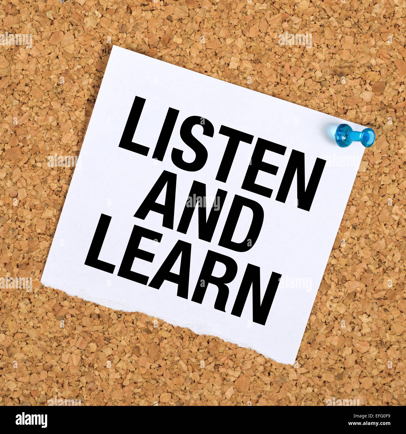 Listen And Learn Reminder Note on Cork Bulletin Board. Stock Photo