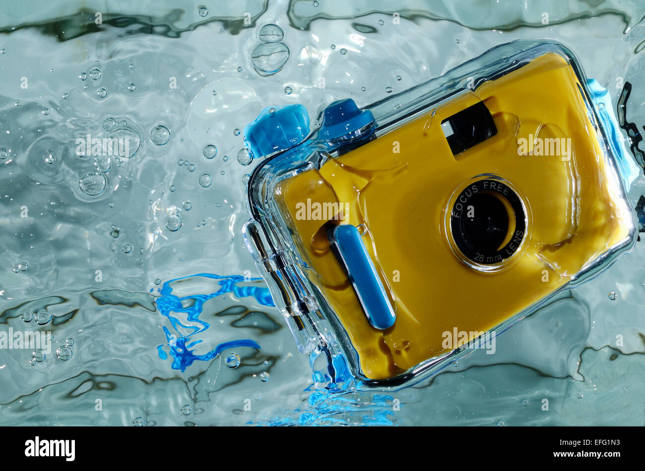 Photo of yellow waterproof camera in water. Stock Photo