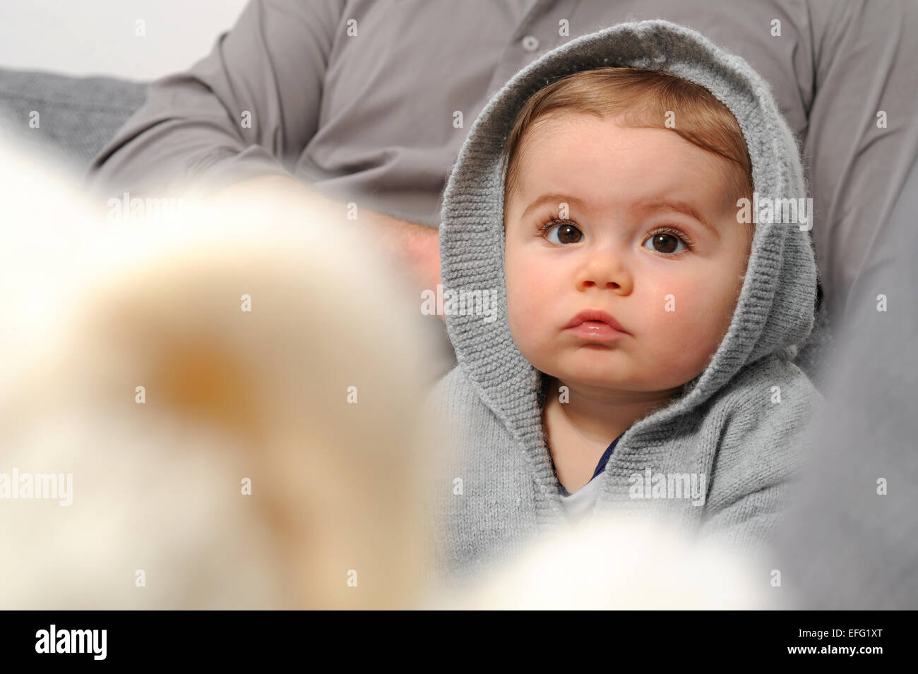 Small child - Baby sitting on sofa Stock Photo