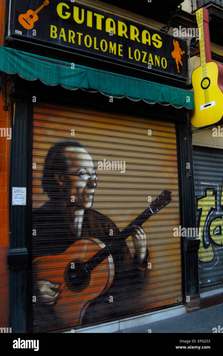 Closed guitar shop, graffiti, artwork, Seville, Spain Stock Photo