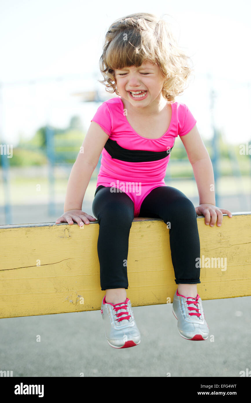 unhappy girl crying on the playground Stock Photo