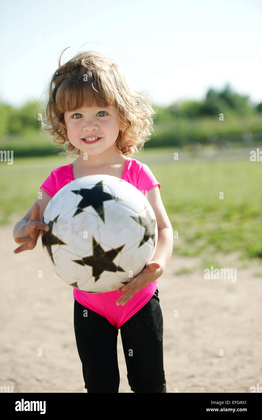 little girl plays football on stadium Stock Photo Alamy