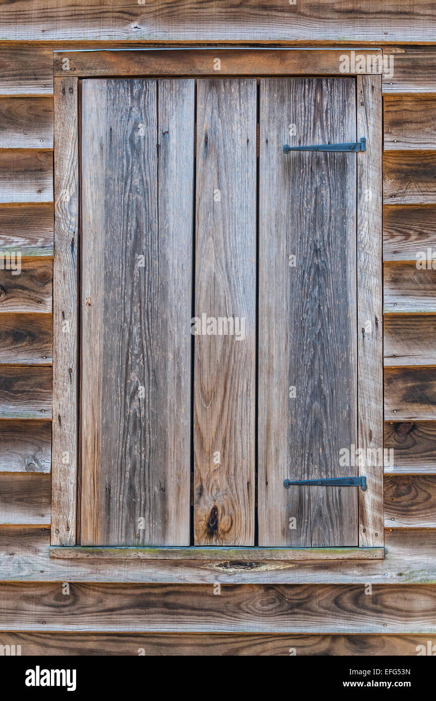 Wood shuttered window on a 19th century slave cabin on the property of Thomas Hudson in Gwinnett County, Georgia. (USA) Stock Photo