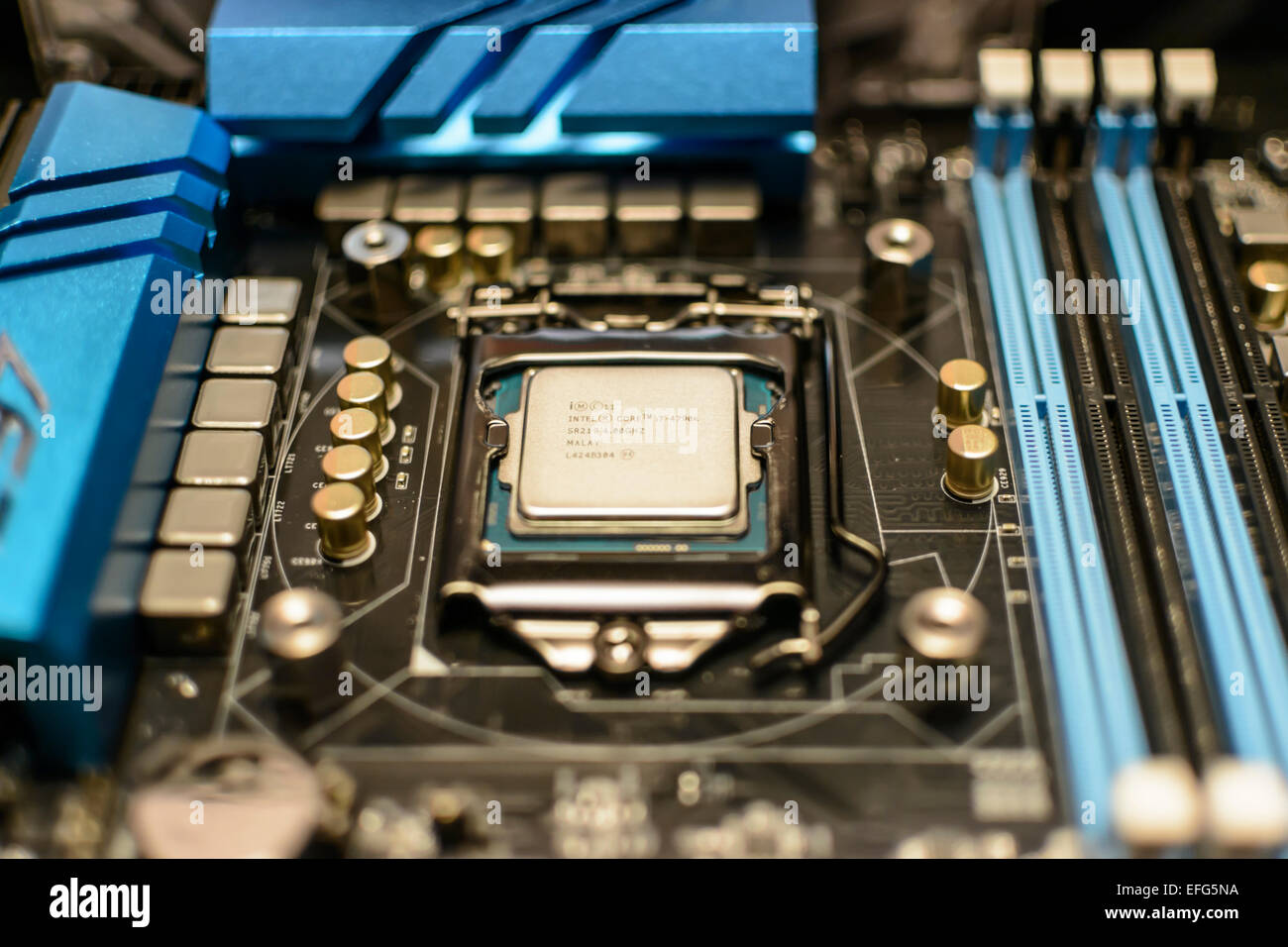 Intel i7 4790K CPU fitted into a computer motherboard without a heatsink. Stock Photo