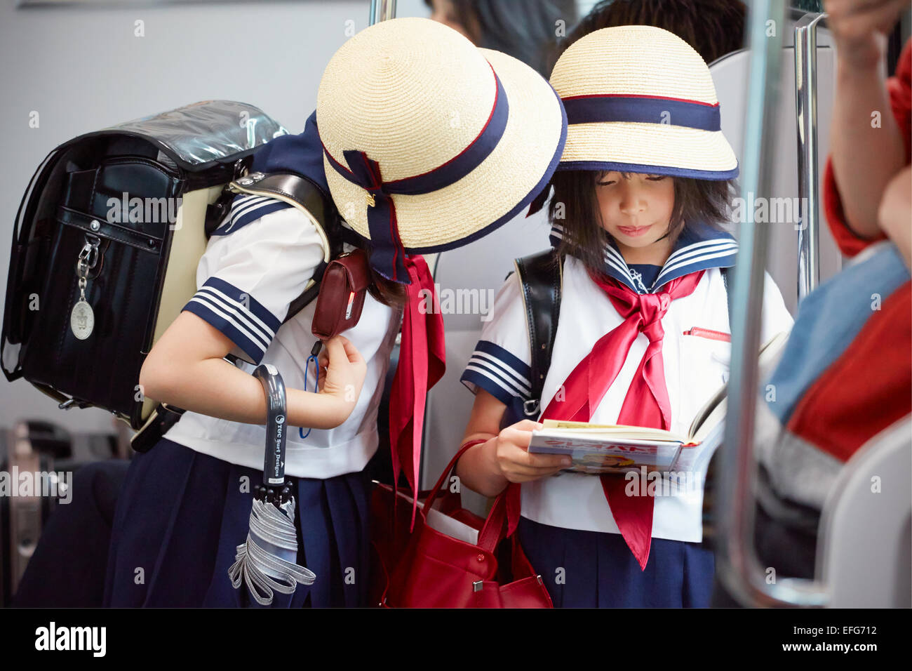 Children in school uniform on train, Tokyo, Japan Stock Photo