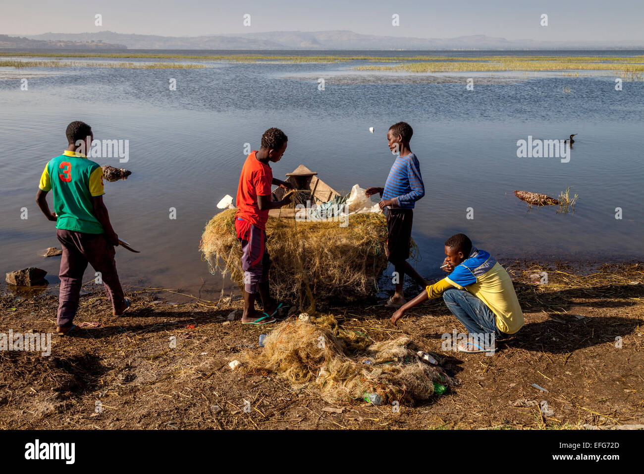 Local Boys Mending Fishing Nets, Lake Hawassa, Hawassa, Ethiopia Stock  Photo - Alamy