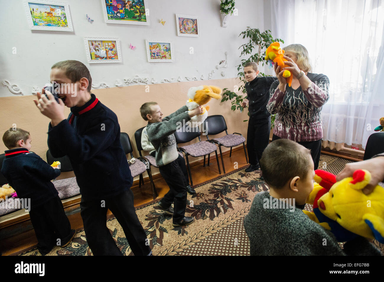 Zhytomyr, Ukraine. 2 of February, 2015. Teterivka's Orphanage and Boarding school has 85 pupils with mental and intellectual disorders, that can't manage without medical and specialists care. Governmental founding is sole way of founding for orphanage. Boys with mental disorders play with their toys in playing room of Teterivka's Orphanage and Boarding school. Zhytomyr, Ukraine. 2 of February, 2015. Credit:  Oleksandr Rupeta/Alamy Live News Stock Photo